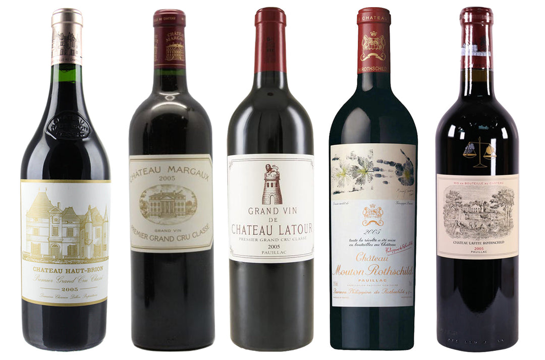 Bottles of the five First Growths of Bordeaux: Lafite Rothschild, Latour, Margaux, Mouton-Rothschild, and Haut-Brion displayed together